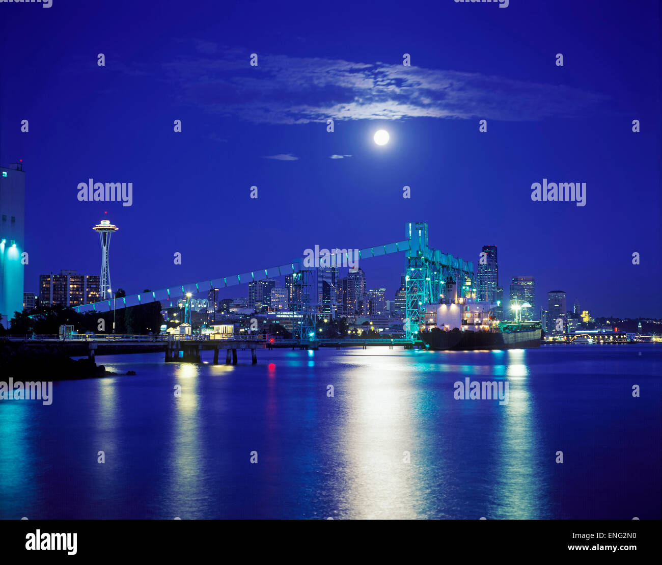 Moon over illuminated Seattle city skyline at night, Washington, United States Stock Photo