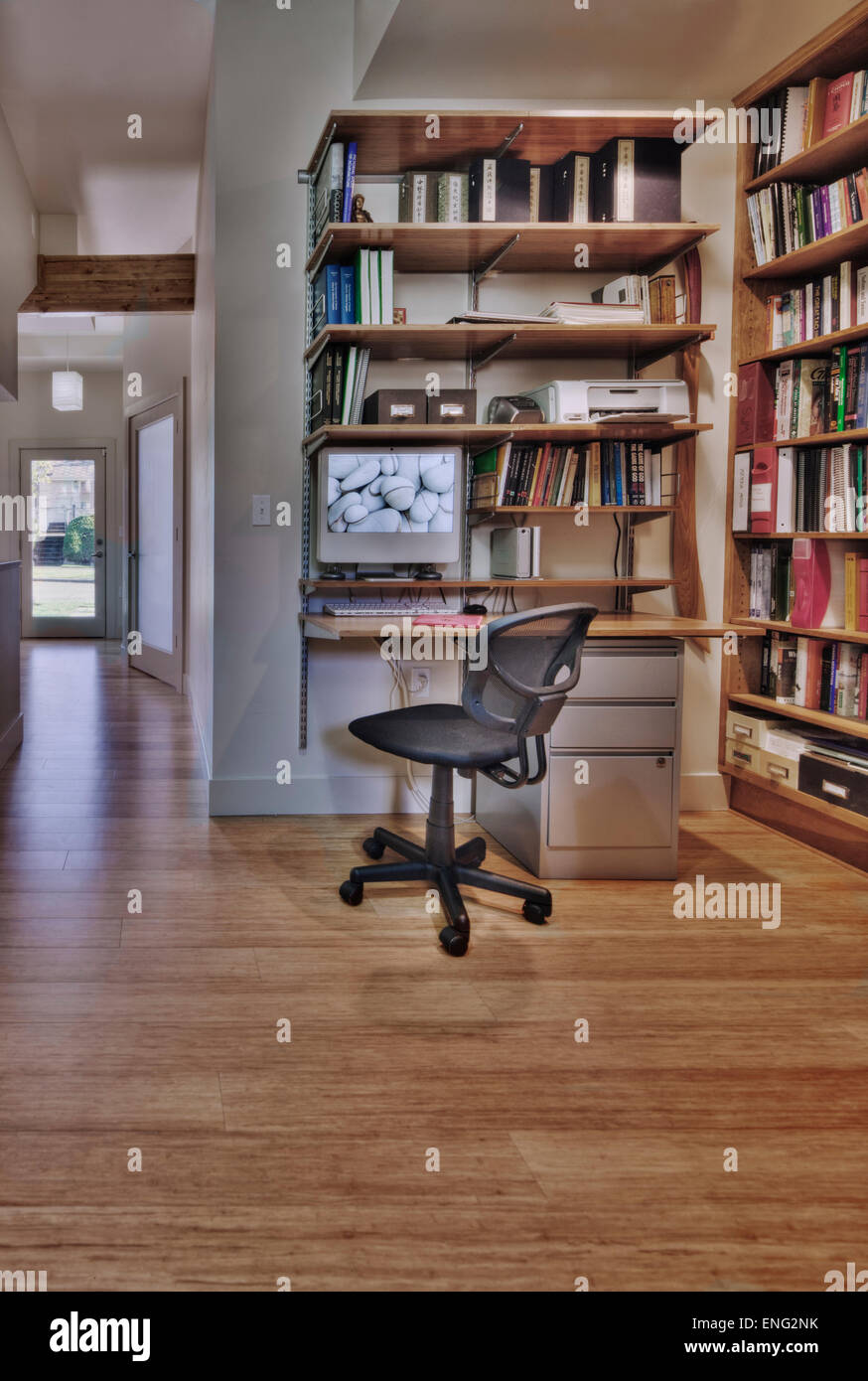 Empty desk and bookshelves in natural healing clinic office Stock Photo