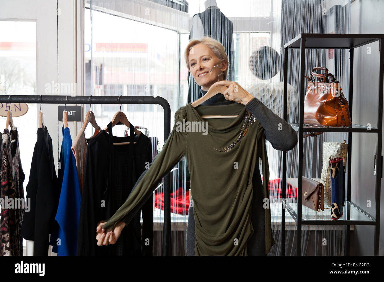 Older Caucasian woman shopping in clothing store Stock Photo
