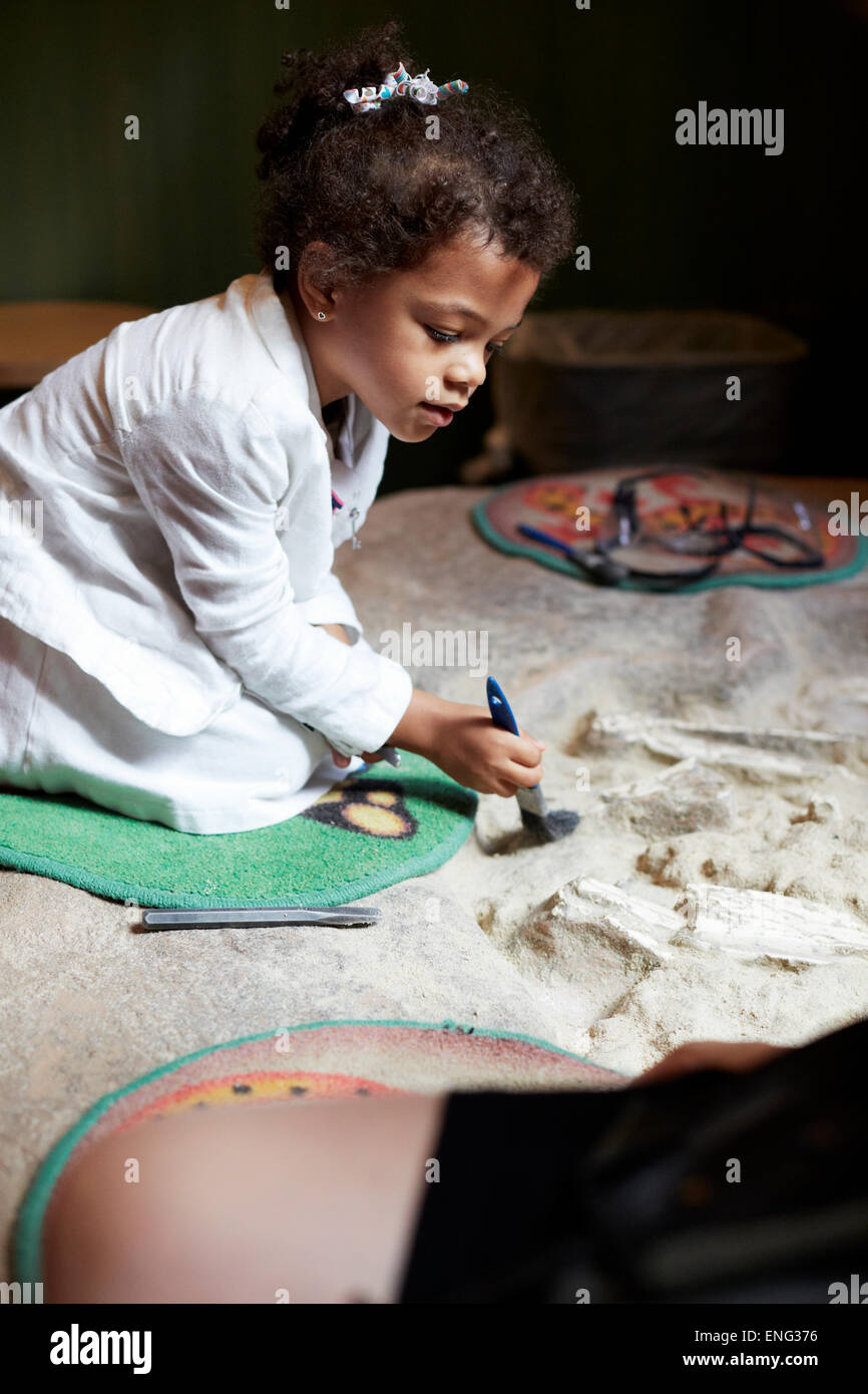 Mixed race girl painting on fabric Stock Photo