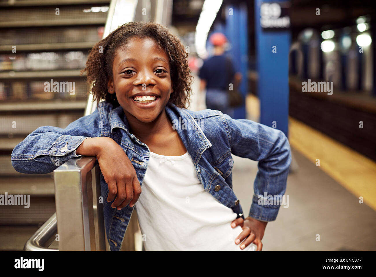 Smiling girl leaning on subway staircase Stock Photo