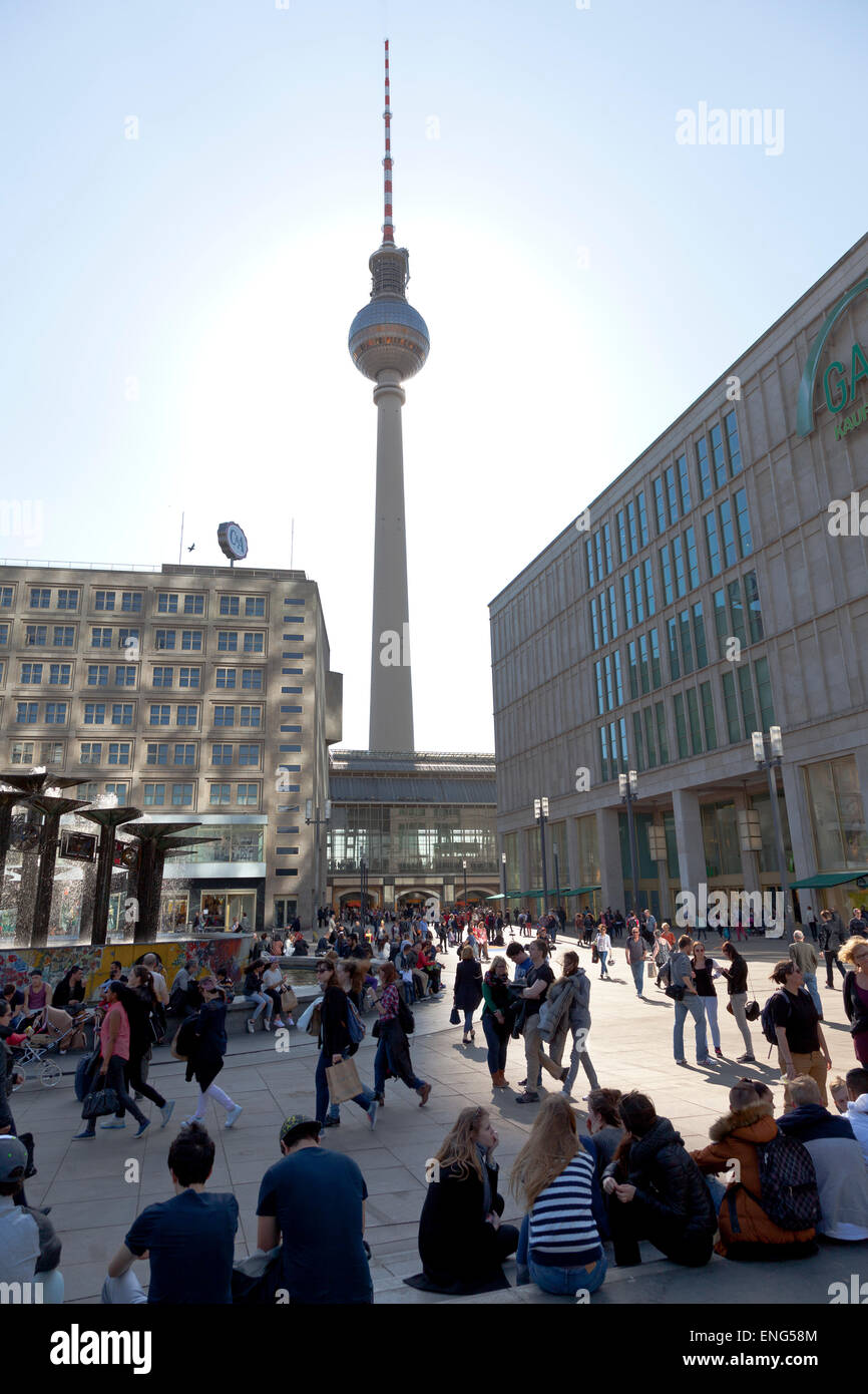 Allexanderplatz with tourisits sitting around in Germany´s Capital City Berlin with the Fernsehturm television tower in the back Stock Photo