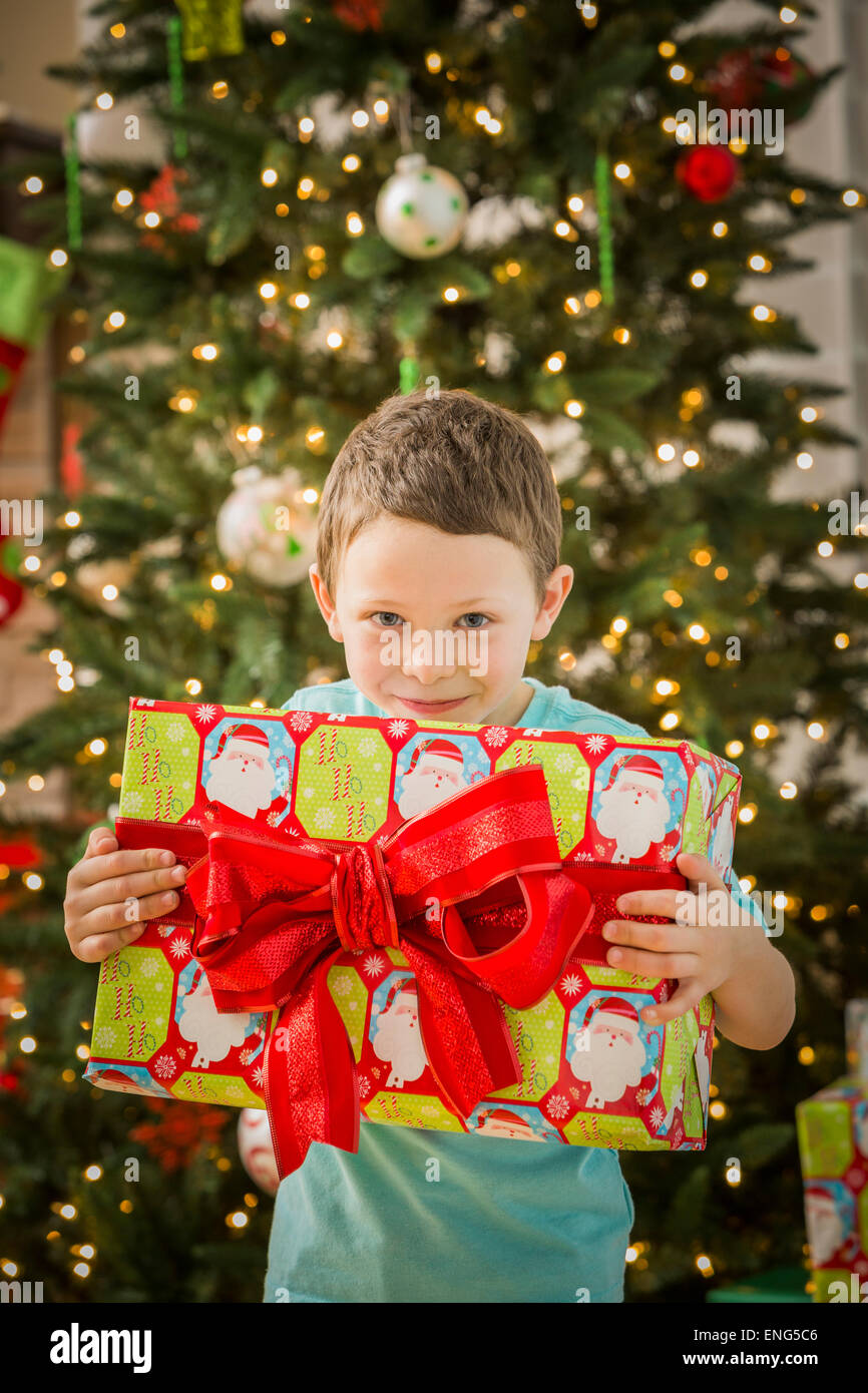 Caucasian boy holding Christmas gift Stock Photo
