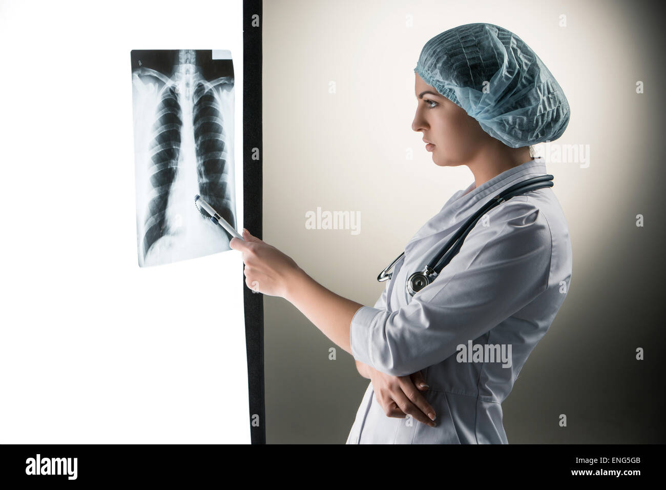 Image of attractive woman doctor looking at x-ray results Stock Photo