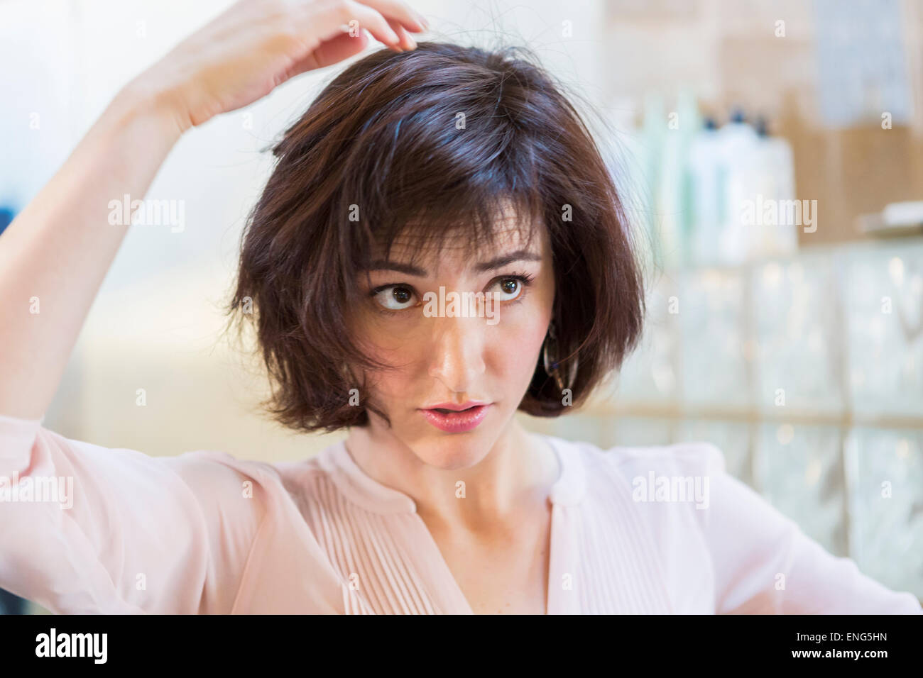 Close up of Hispanic woman examining her hair Stock Photo