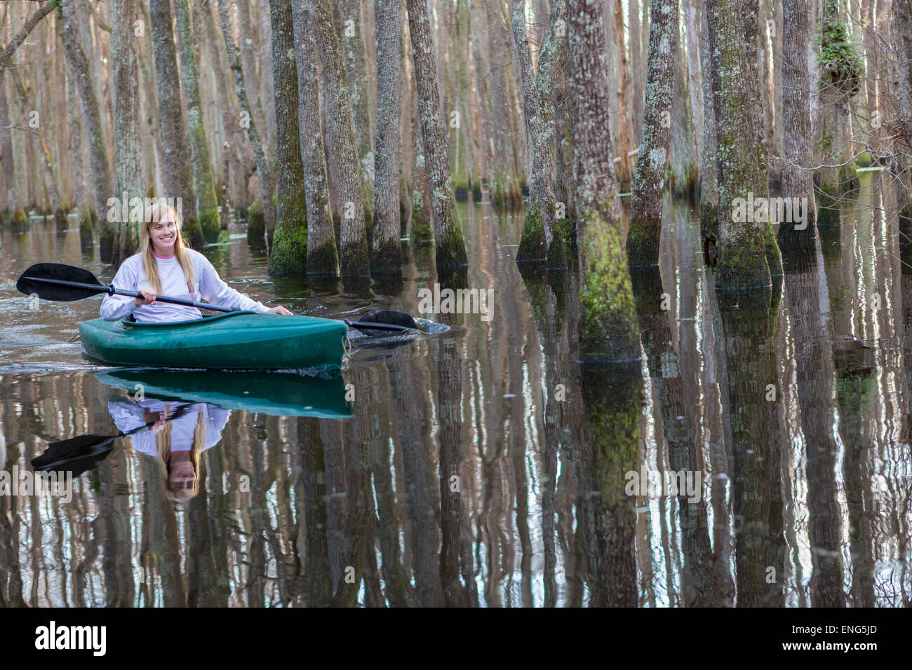 Caucasian woman rowing canoe in river Stock Photo