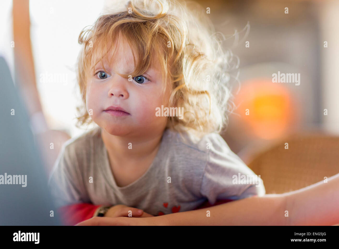 Caucasian baby boy peering at computer screen Stock Photo