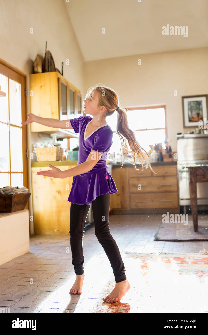 Caucasian girl dancing in kitchen Stock Photo Alamy