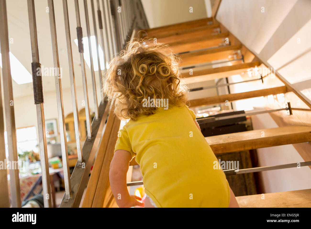 Caucasian baby boy crawling up stairs Stock Photo
