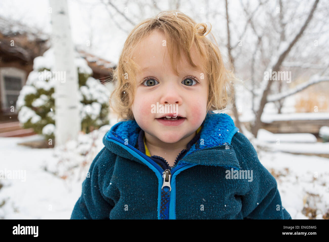 Caucasian boy standing in snow Stock Photo