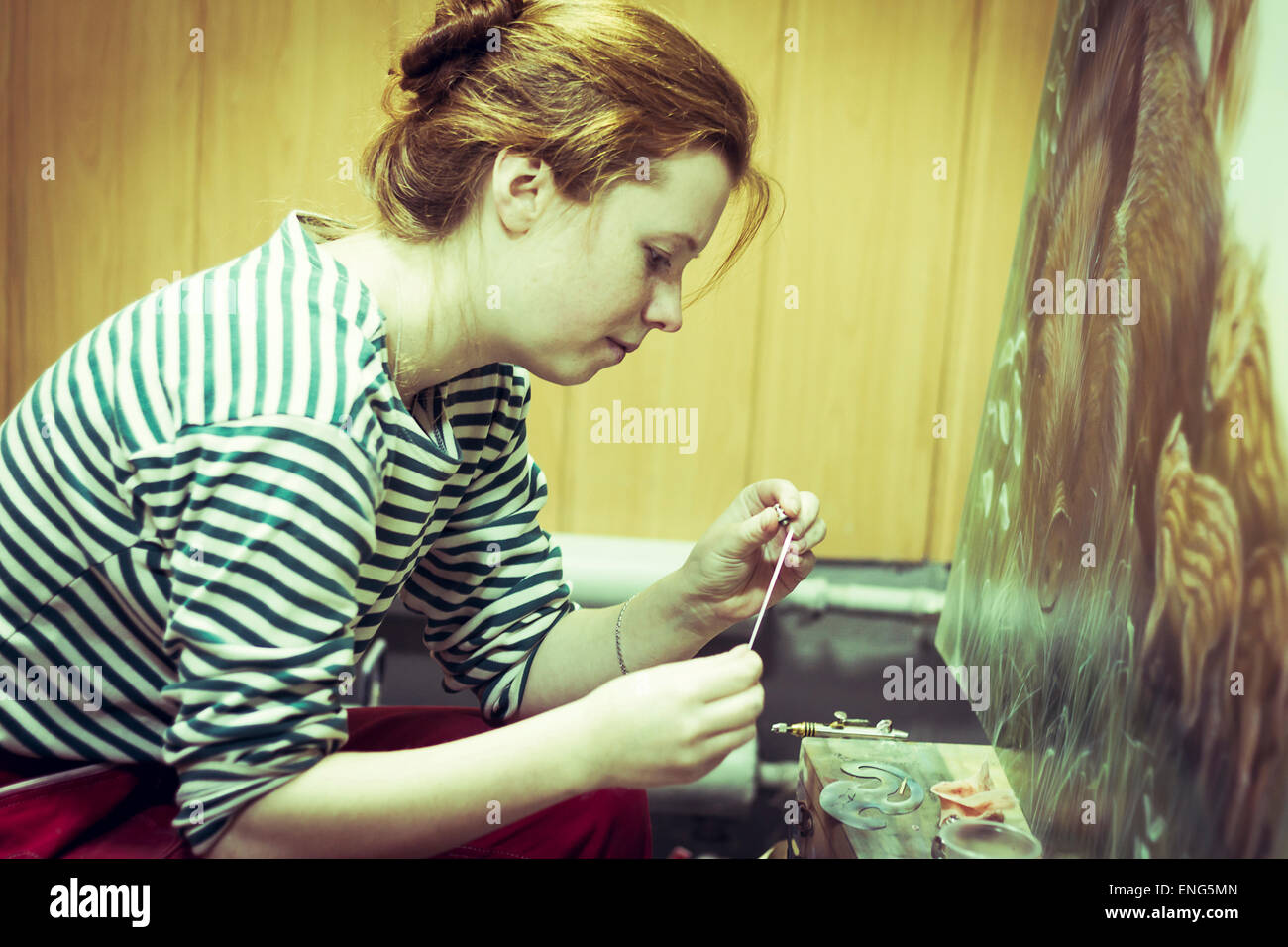 Artist working on painting in studio Stock Photo
