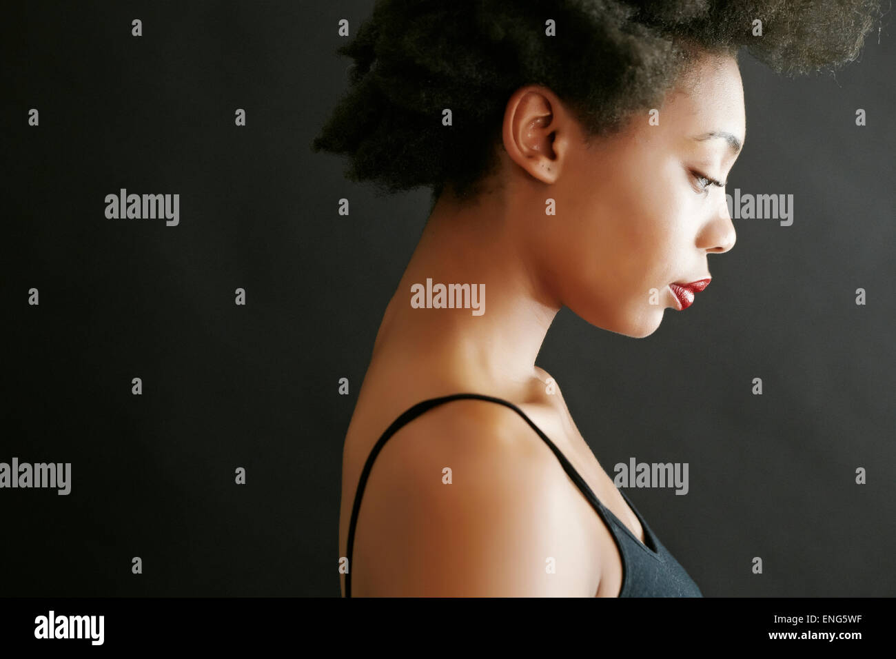 Close up profile of black woman looking down Stock Photo