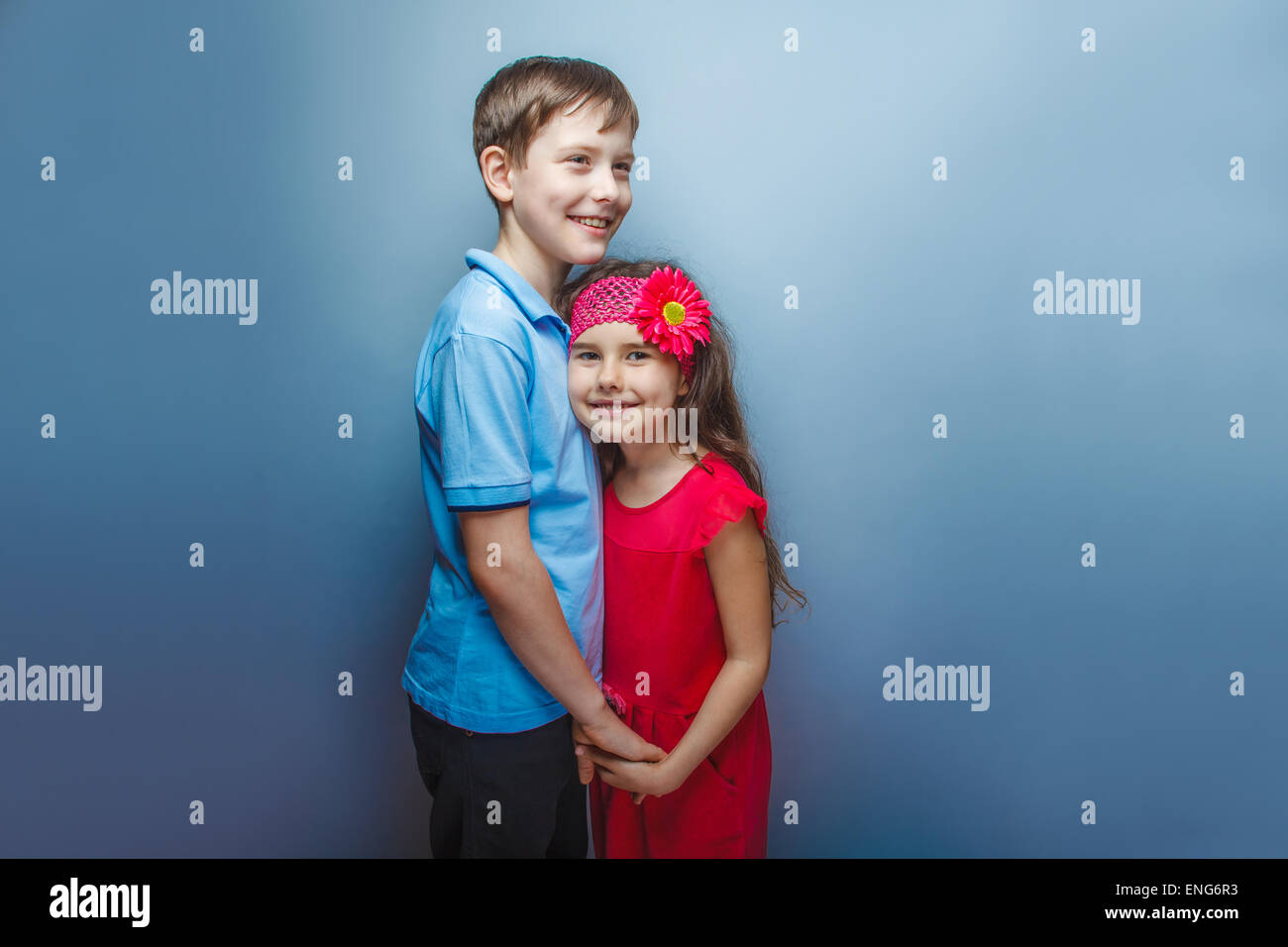 teen girl holding hands teenage boy on a gray background Stock Photo ...
