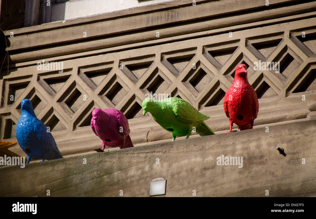Ceramic Pigeons on a window ledge, city centre Stock Photo