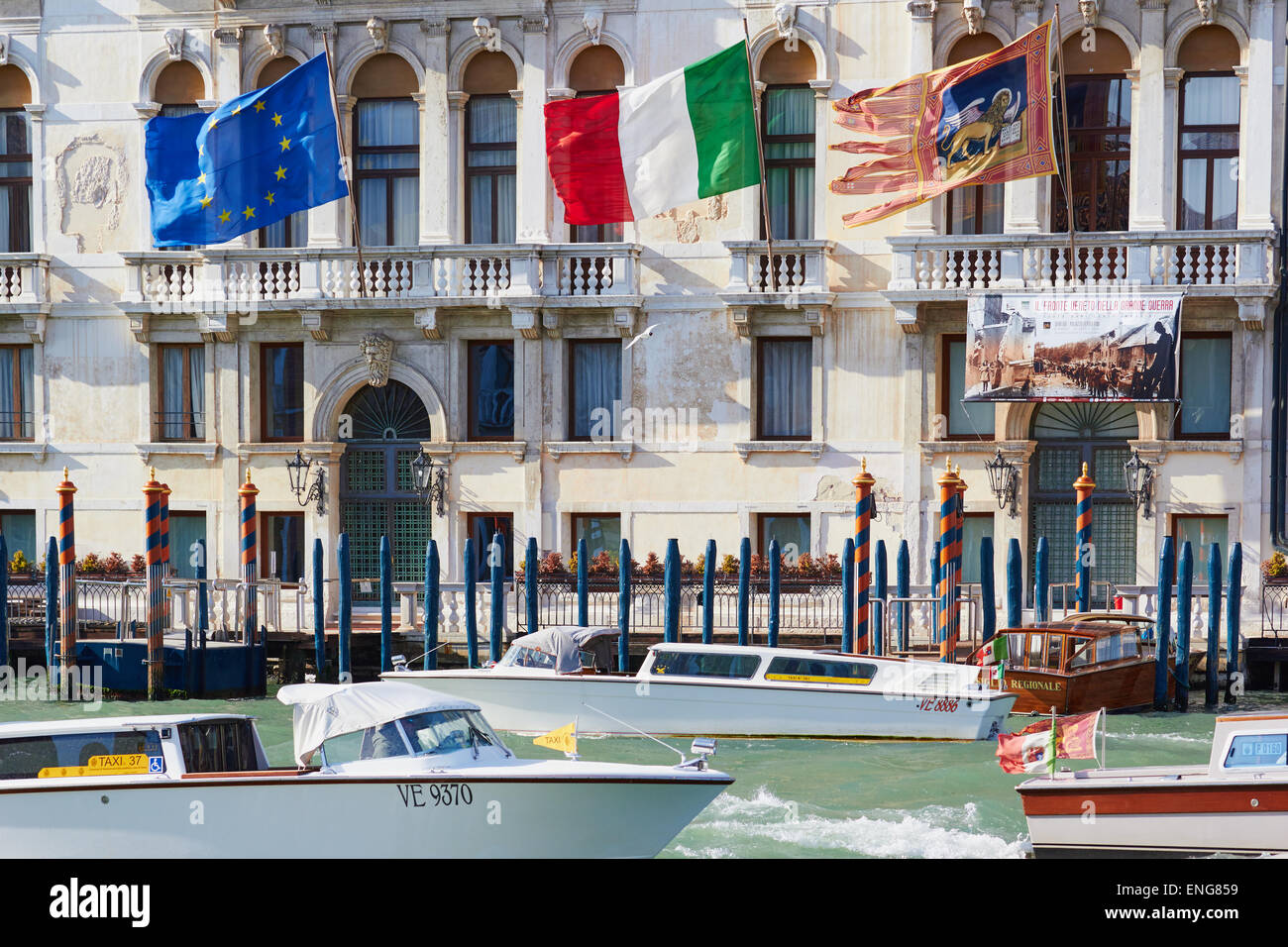 Water taxis on the grand canal passing Palazzo Ferro Fini Venice Veneto Italy Europe Stock Photo