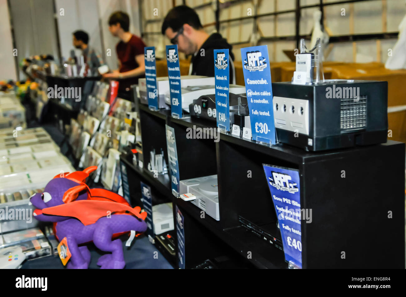 Retro video game consoles and cartridges for sale at a market stall Stock Photo