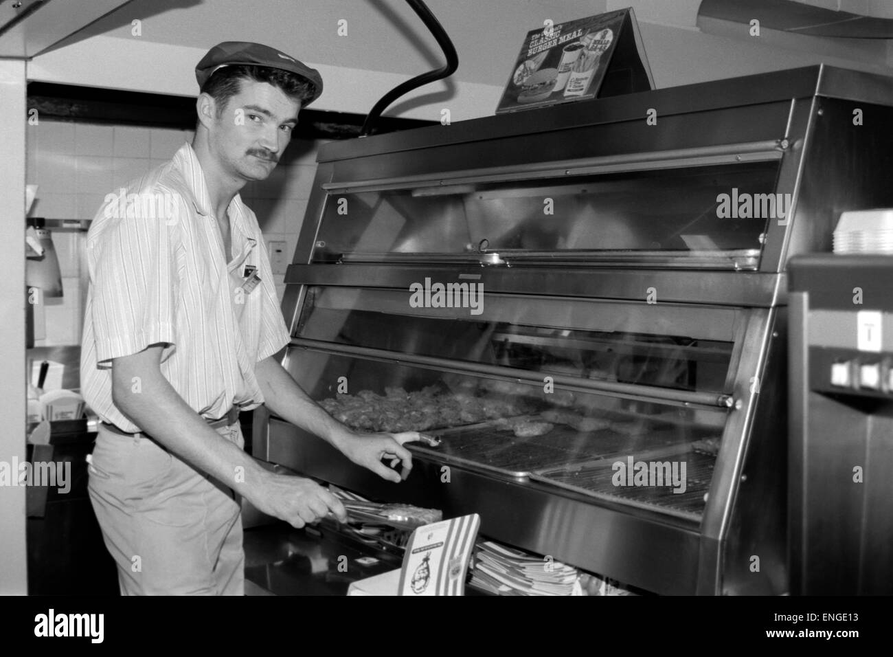 male employee working in a fast food kfc fried chicken shop in the 1990s Stock Photo