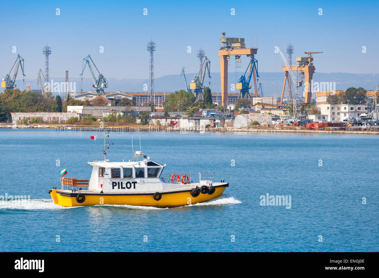 Yellow and white small pilot boat enters the port of Varna, Bulgaria Stock Photo