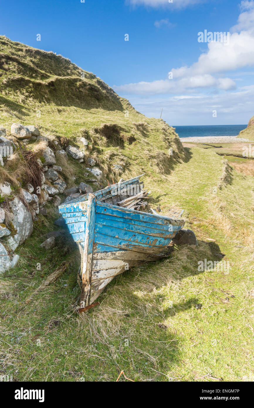 A blue boat on the shore on a sunny day Stock Photo