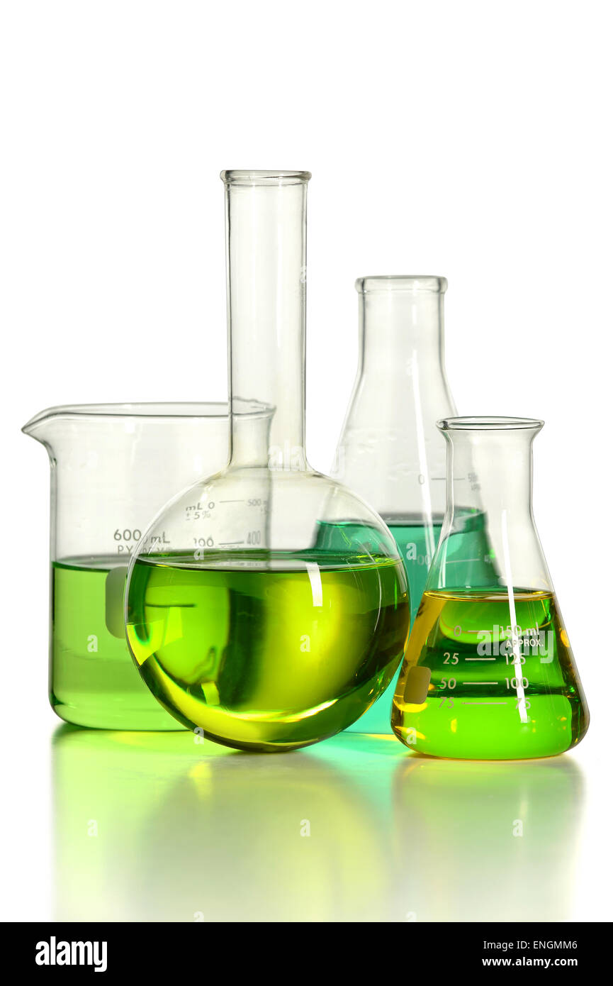 Assortment of laboratory glassware with green liquid isolated over