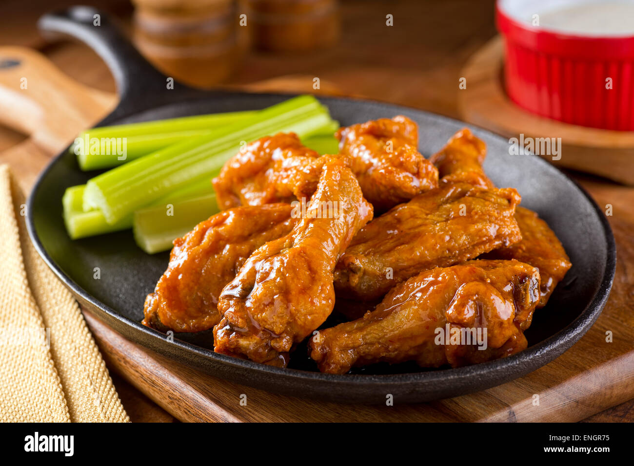 A plate of delicious Buffalo style chicken wings with celery and dipping sauce. Stock Photo