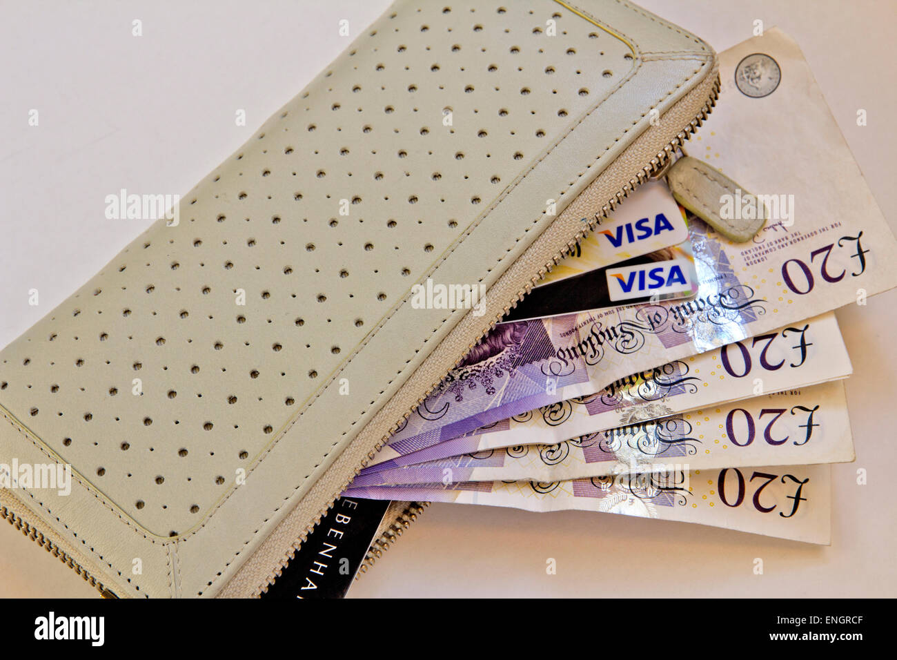 Money, Notes, and Credit Cards spilling from a wallet. Stock Photo