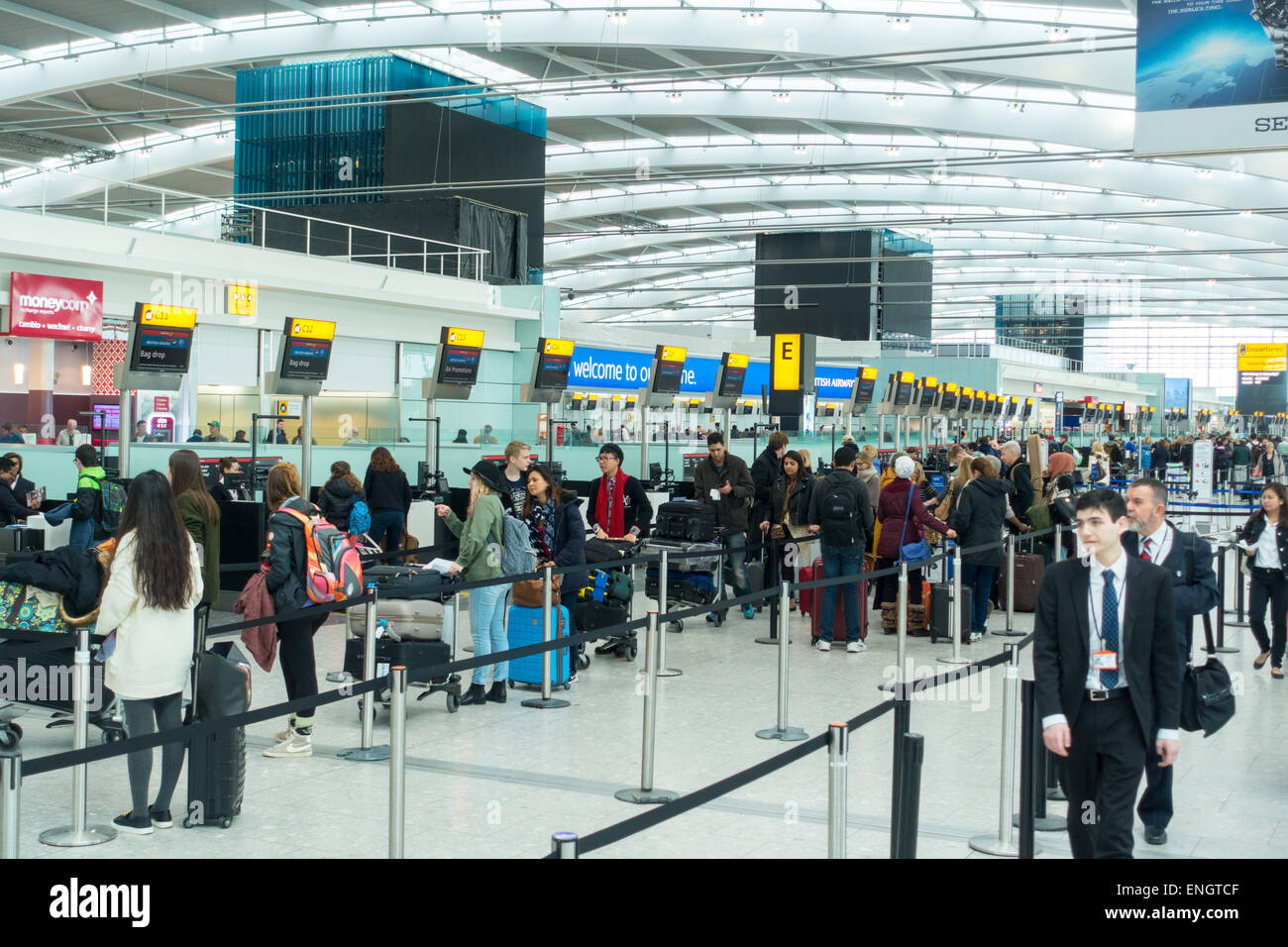 Heathrow Terminal 5 passengers checking in Stock Photo - Alamy