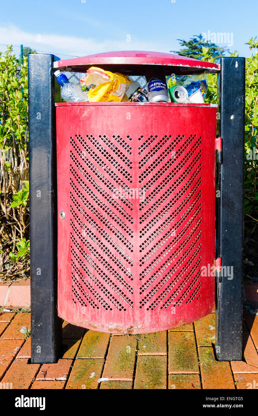 Overflowing rubbish bin in a public park Stock Photo