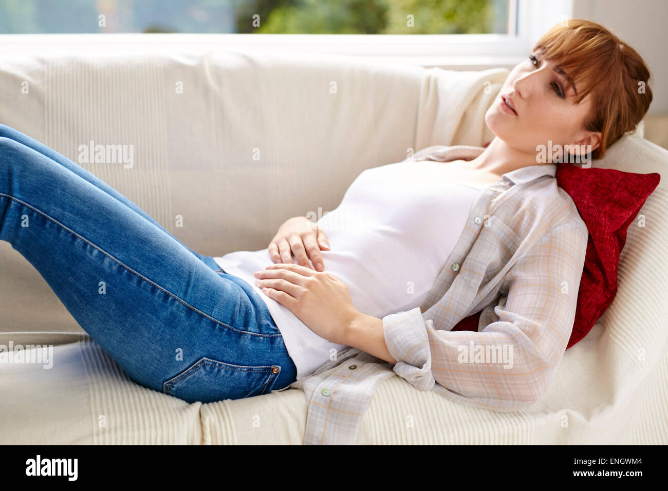Girl holding her abdomen Stock Photo