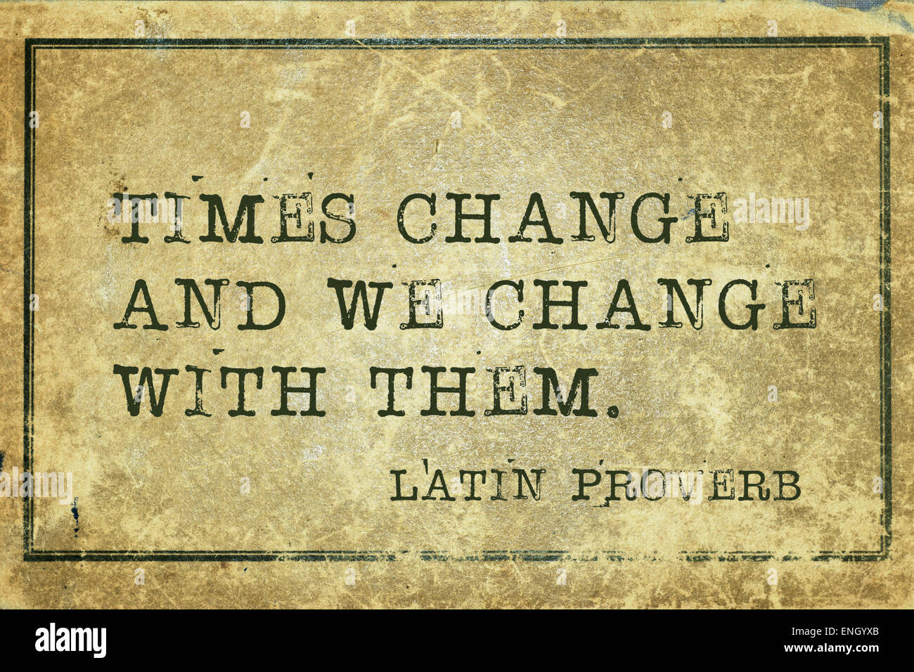 Times change and we  -  ancient Latin proverb printed on grunge vintage cardboard Stock Photo