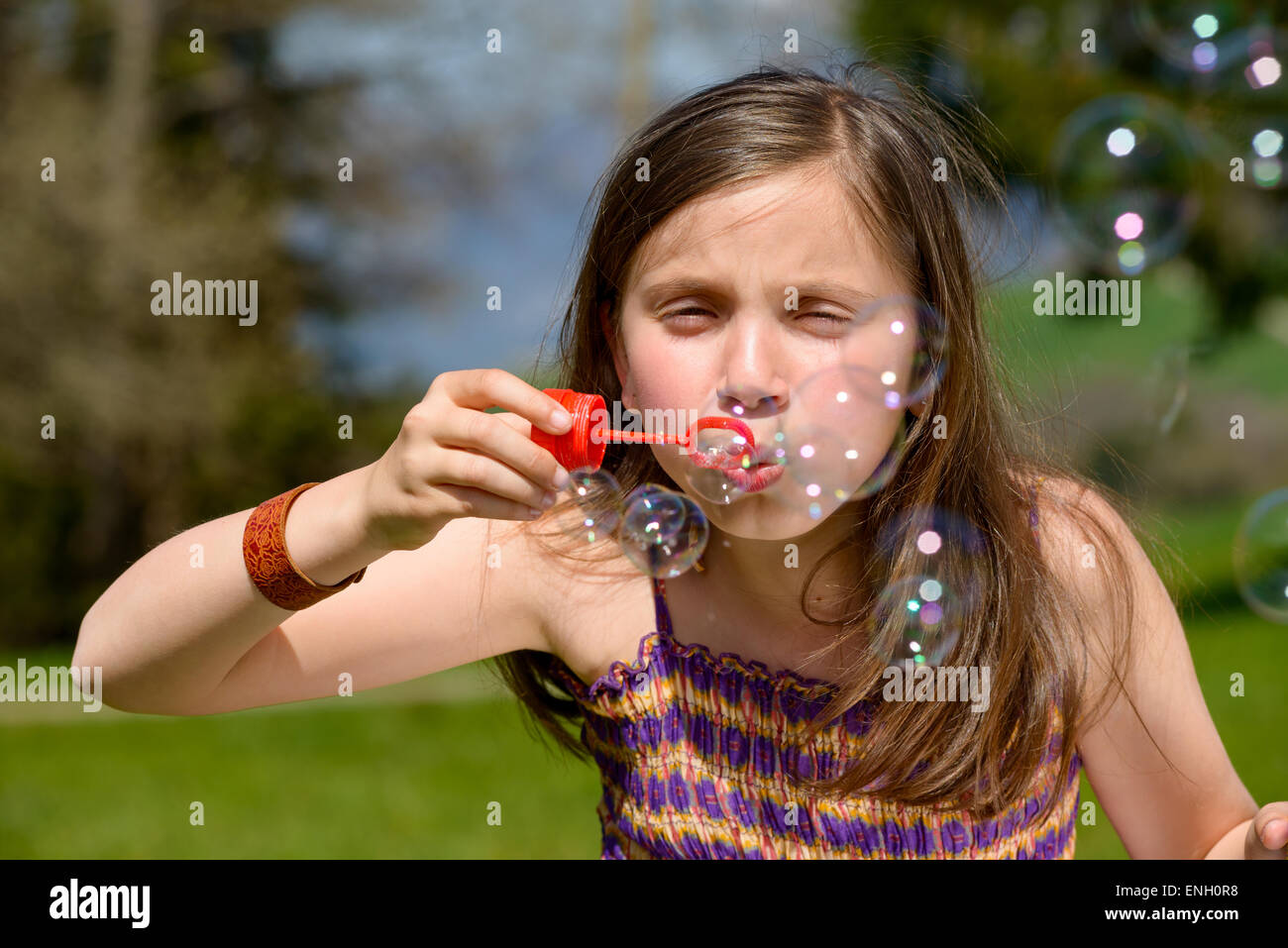a little girl making soap bubbles in nature Stock Photo - Alamy
