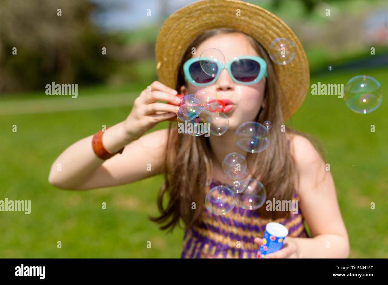 a little girl making soap bubbles in nature Stock Photo - Alamy