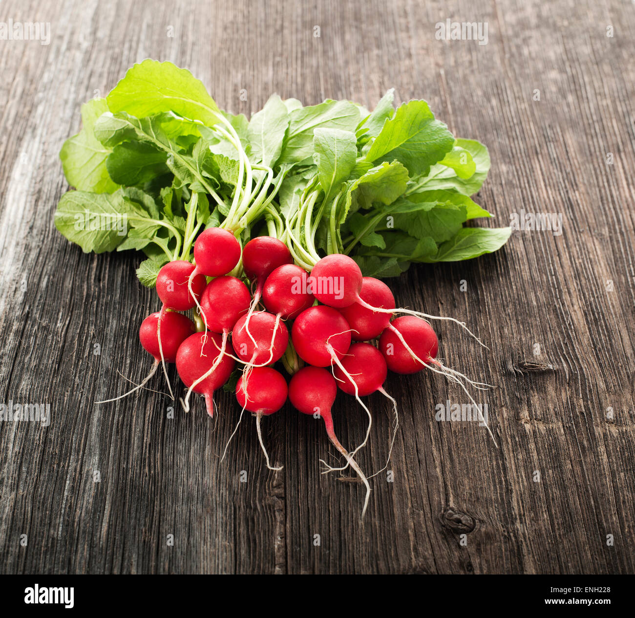 Bunch of fresh red radish on wooden table Stock Photo