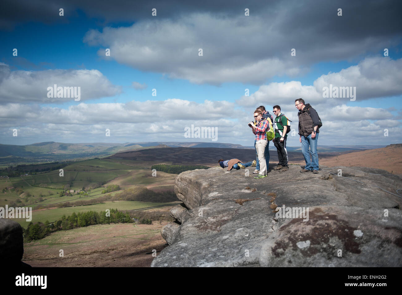 Walkers taking photographs on Stanage Edge in the Peak District Stock Photo