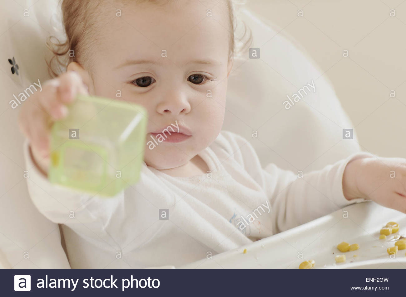 Caucasian One Year Old Baby Boy Eating Sweetcorn In A White