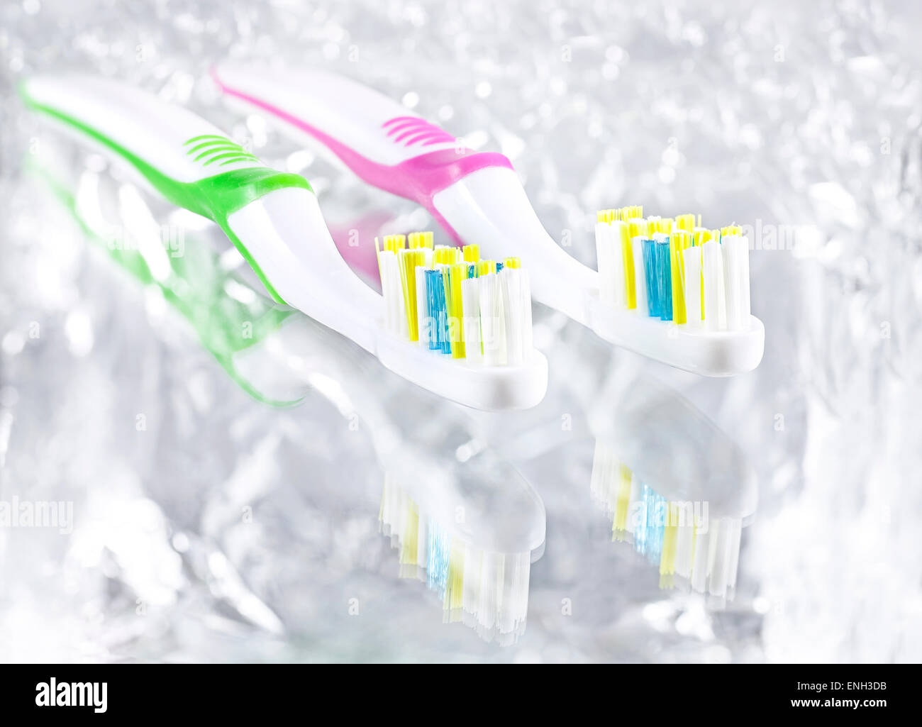 Two tooth brushes on bright background, high key effect. Stock Photo