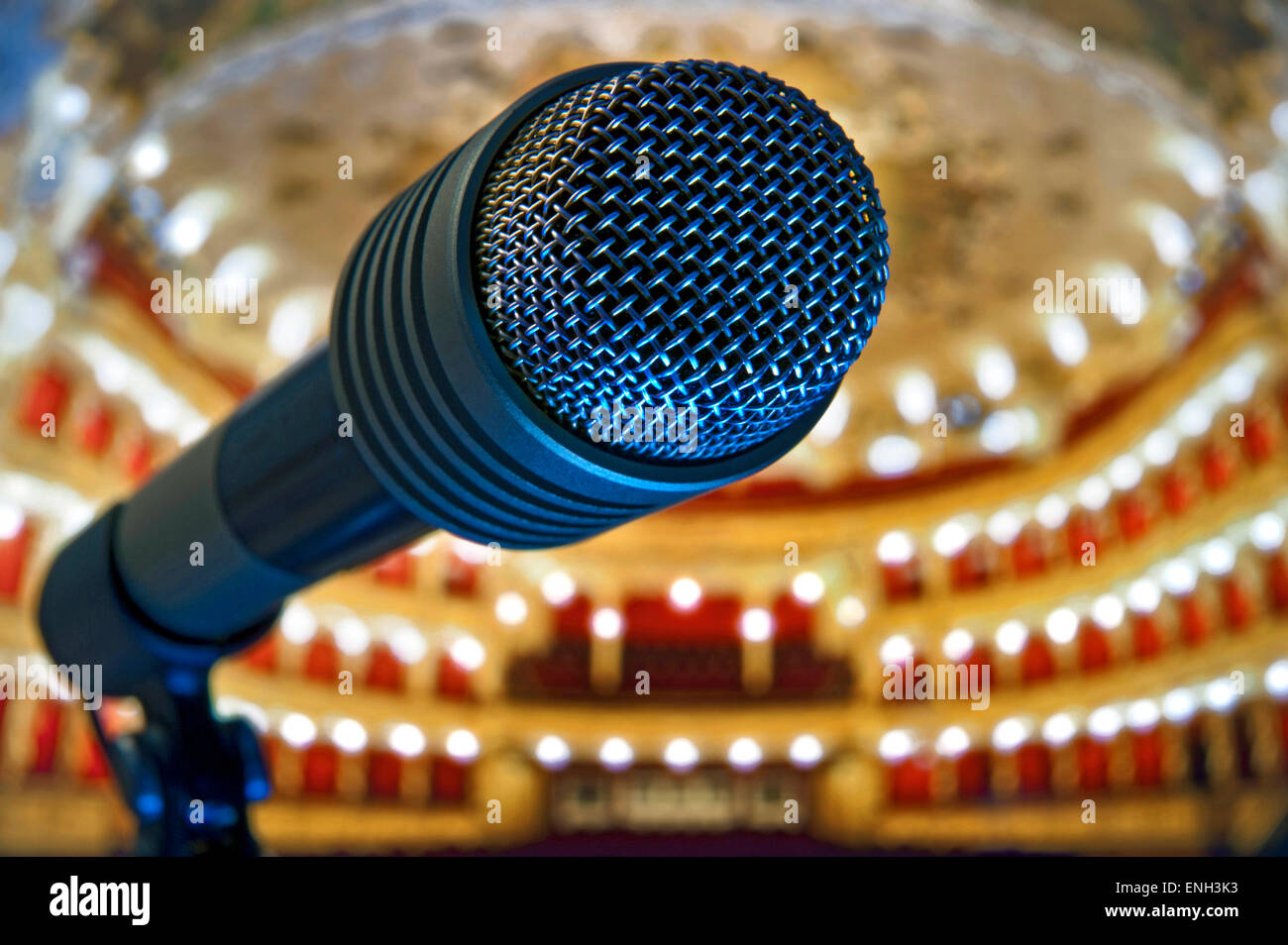 MICROPHONE STAGE THEATRE PERFORMANCE Concept/Close view on microphone on stage with plush traditional theatre auditorium interior in background Stock Photo