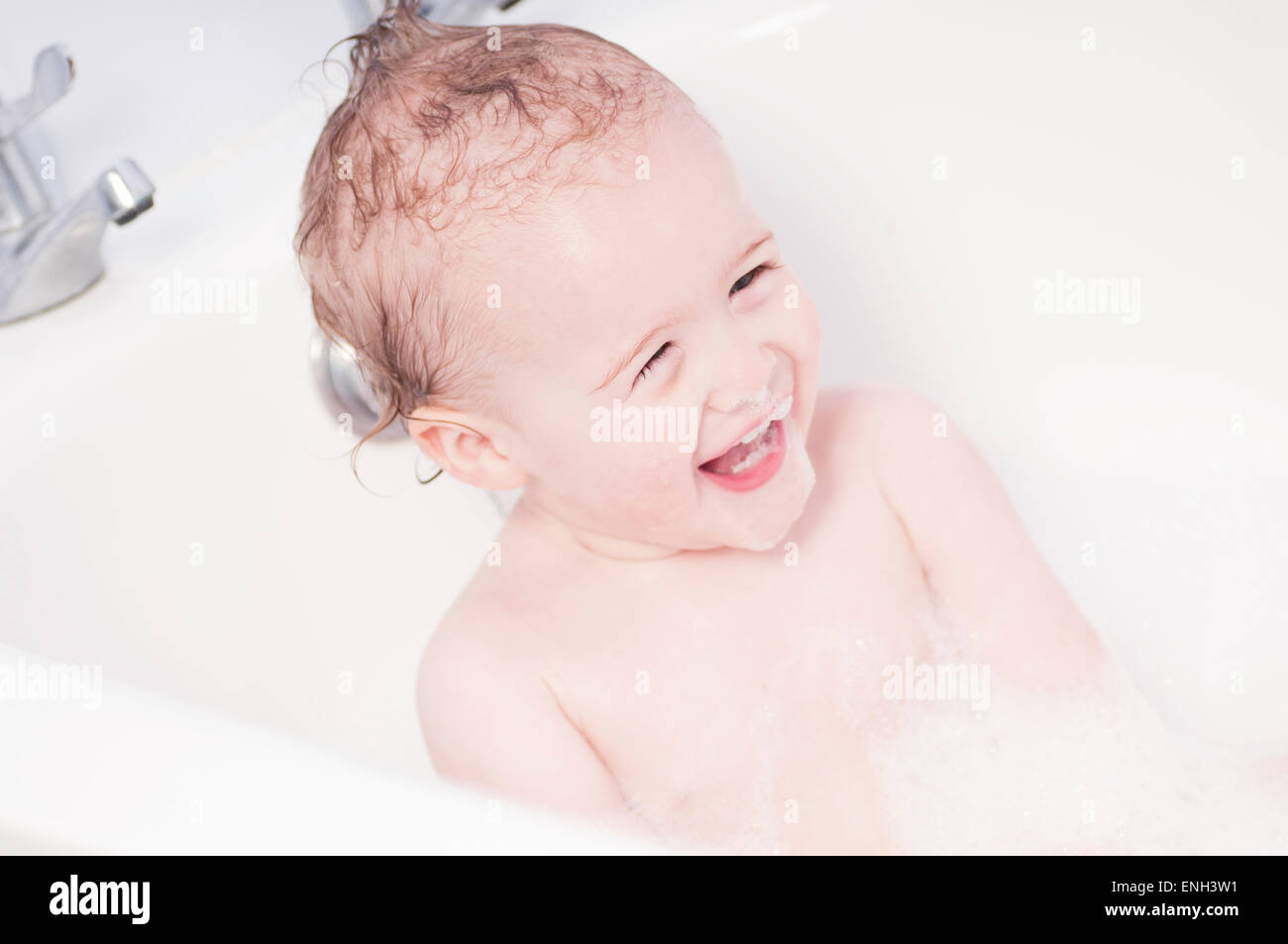 Laughing toddler boy in a bath Stock Photo