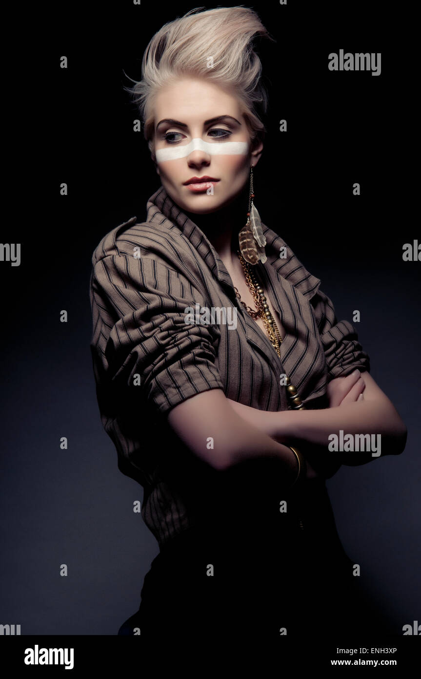 Adam Ant style fashion portrait of young woman with blonde quiff hairstyle Stock Photo