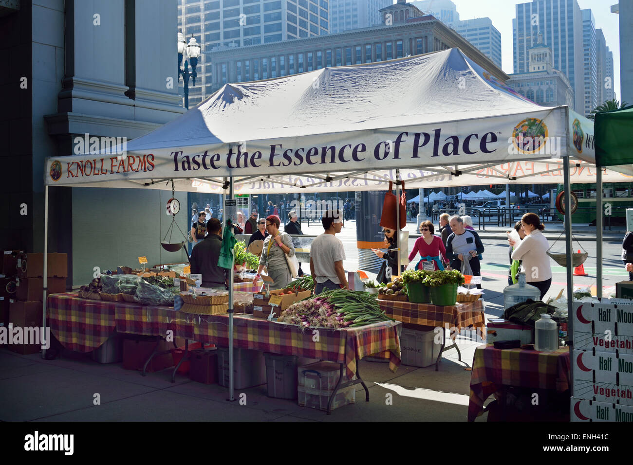 Farmers Market stalls on Embarcadero with contrasting city financial