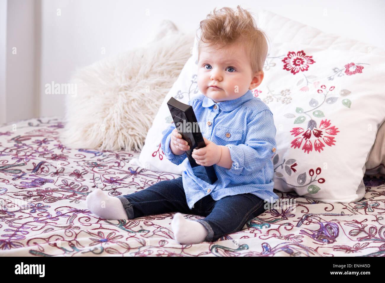 Eight month old baby watching television Stock Photo