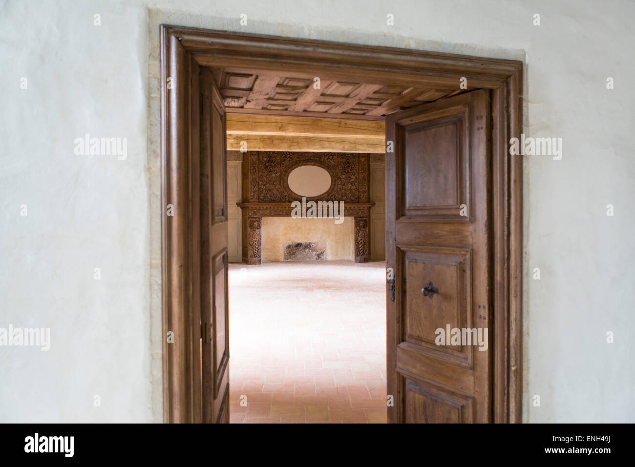 Room with doors and an enormous fireplace at castle Bruniquel, Tarn et Garonne, Midi-Pyrenees, France Stock Photo