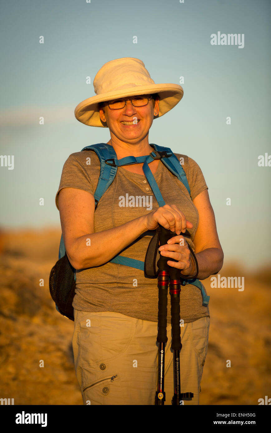 Africa, Namibia. Sossus Dune Lodge.  Namib Desert. Sossusvlei, Naukluft Park. Woman hiking at sunset. Model Released. Stock Photo