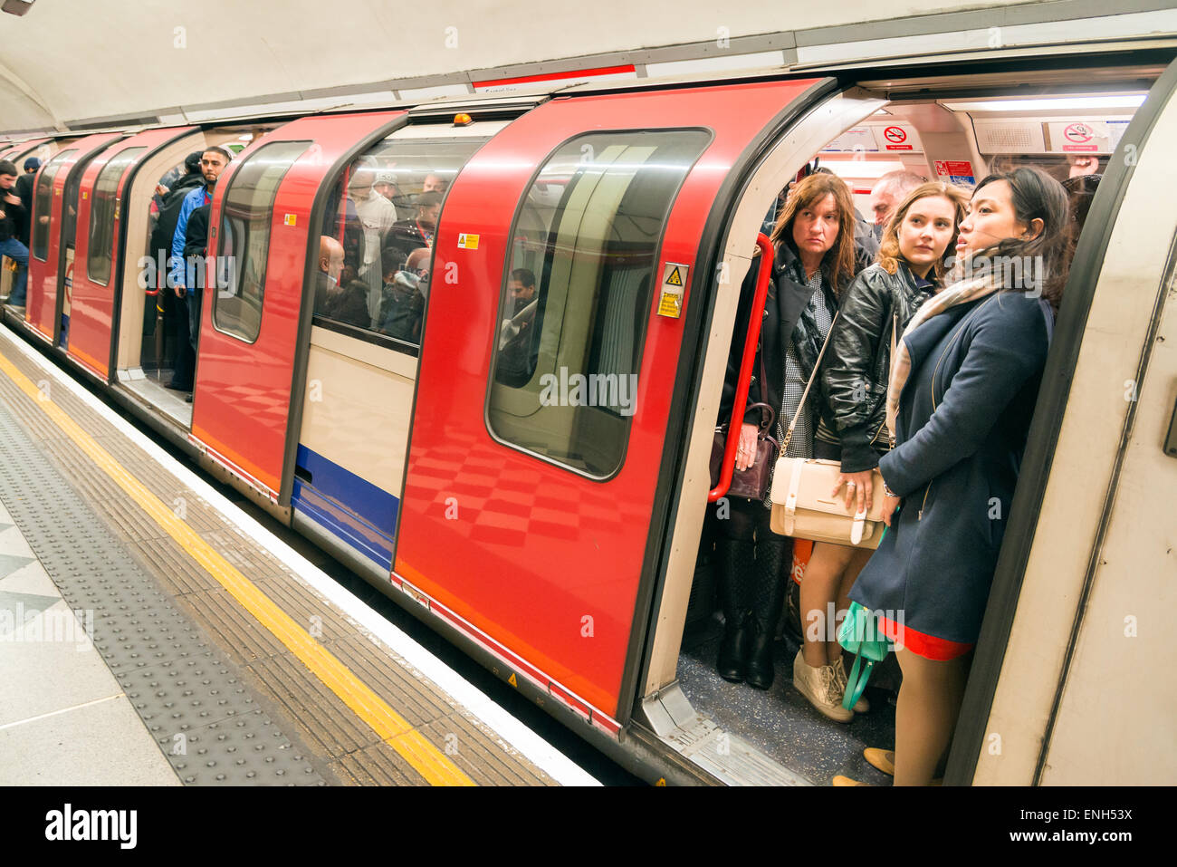 Commuters travelling on overcrowded Central Line London Underground carriage during the morning