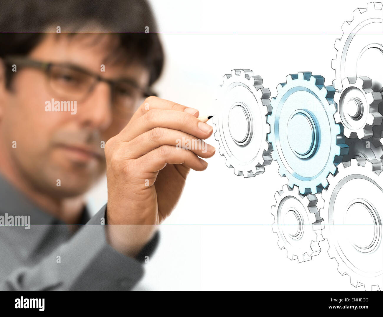 Caucasian engineer drawing gears on a transparent wall. Engineering background concept over white. Stock Photo