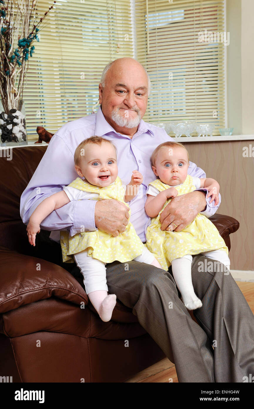 Britain's oldest dad of twins Richard Roden (71) with his  wife Lisa (25) and their identical twins Ruby(L) and Emily(R) Stock Photo