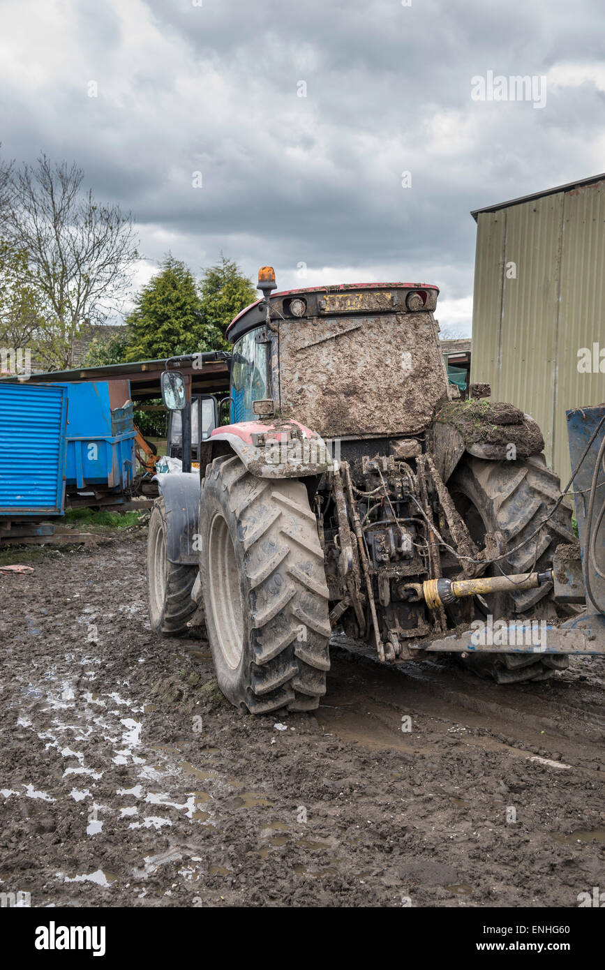 Tractor covering in mud after muck spreading. Standing in the muddy