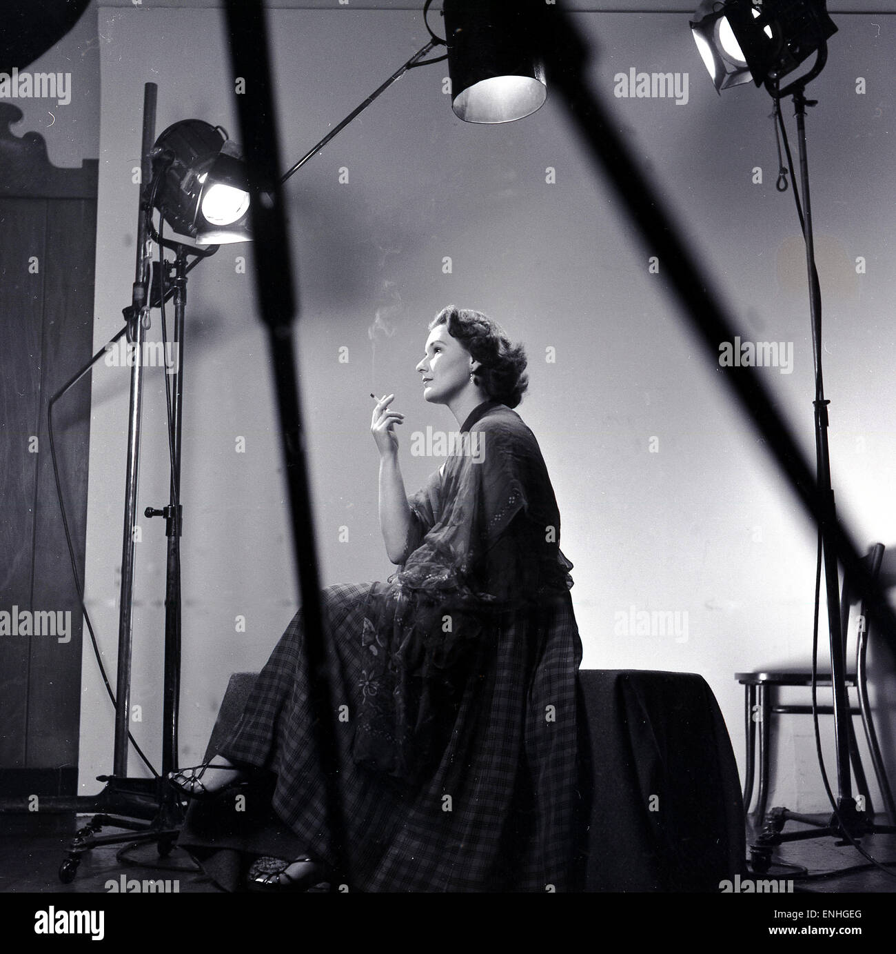1950s, historical, england, amateur dramatics, off stage, but under the spotlights, actress enjoys a cigarette break. Stock Photo