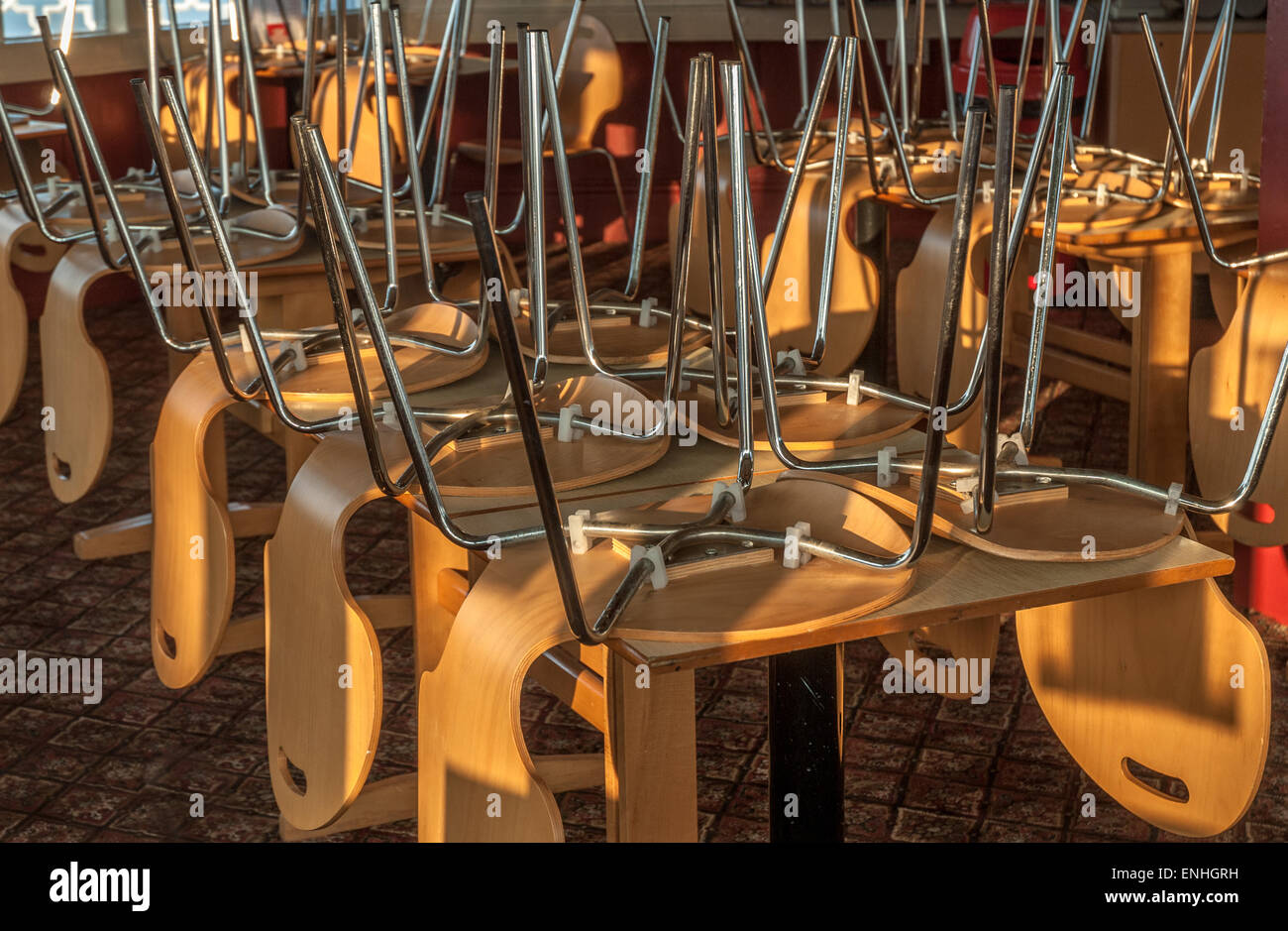 Chairs and tables stacked in a closed restaurant Stock Photo Alamy