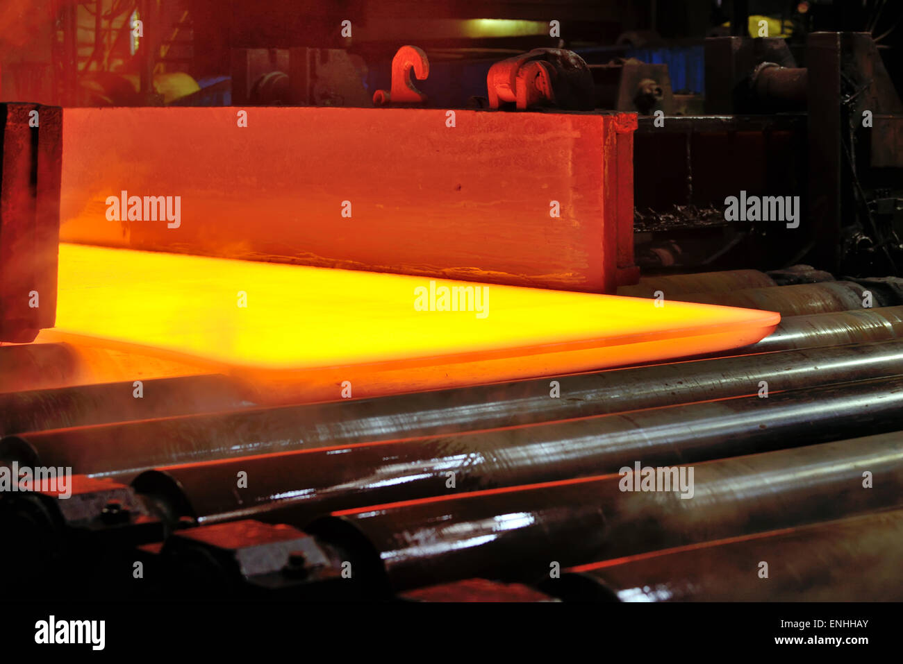 hot steel plate on conveyor inside of plant Stock Photo